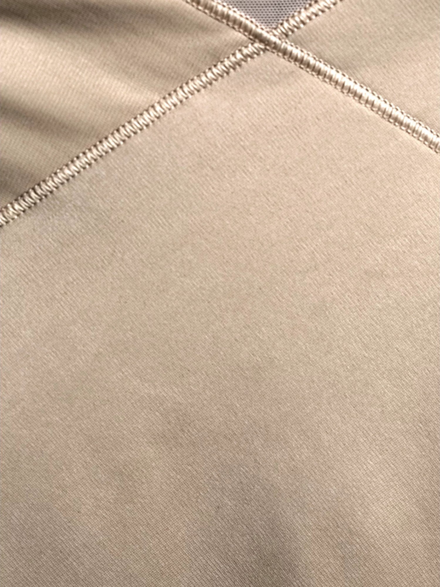 a close-up detail of a beige shaping short