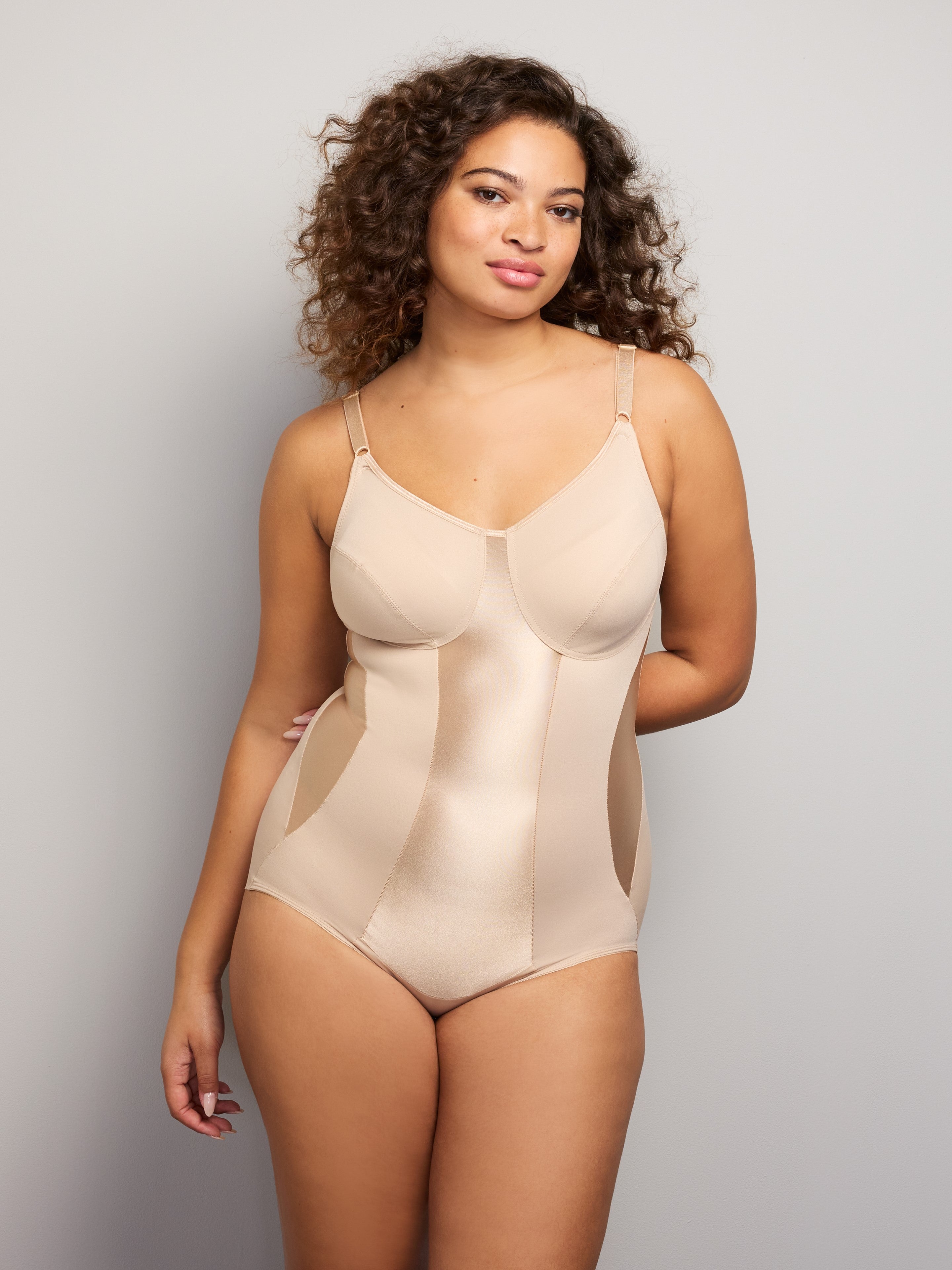 a woman wearing a nude tummy control shapewear bodysuit all-groups