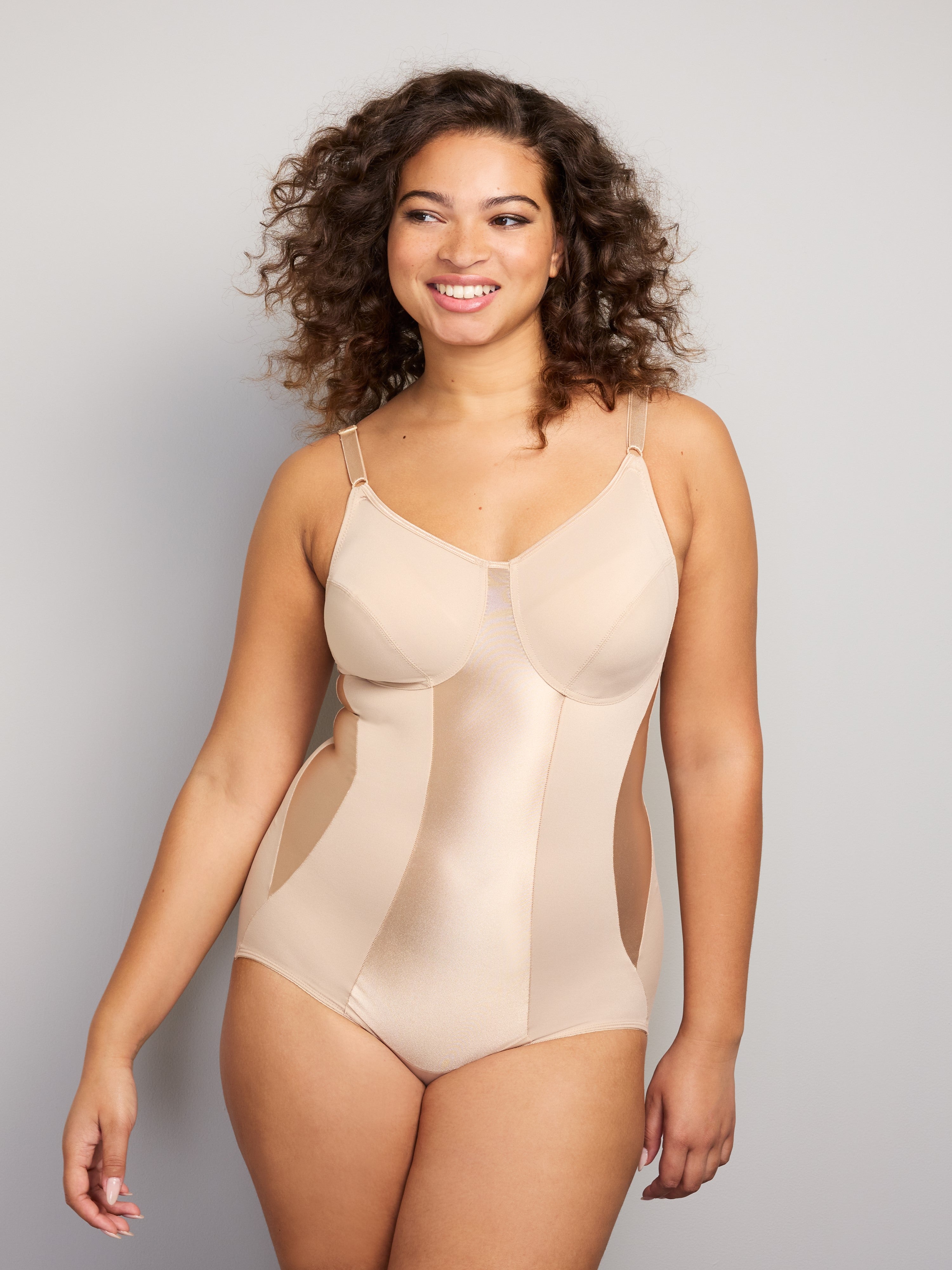 a woman wearing a beige shaping bodysuit