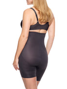 a woman wearing a black high waisted tummy control shapewear short