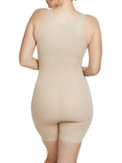 a woman wearing a beige open-bust shaping bodysuit romper