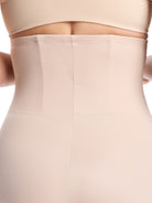 a close-up detail of a woman wearing nude high waisted tummy control underwear shapewear