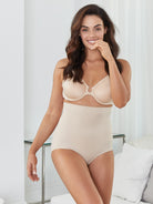 a woman in a living room wearing nude high waisted tummy control underwear shapewear