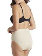 a woman wearing a beige shaping brief