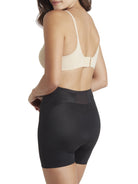 a woman wearing black tummy control shapewear shorts