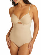 a woman wearing a beige shaping brief