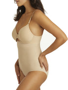 a woman wearing a beige shaping brief