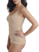 a woman wearing a beige shaping camisole