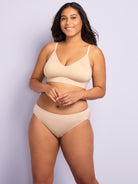 a woman wearing a nude hipster panty and a beige bralette all-groups