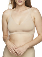 a woman wearing a nude bralette