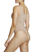 a woman wearing a nude tummy control thong body shaper bodysuit shapewear