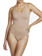 a woman wearing a nude tummy control thong body shaper bodysuit shapewear