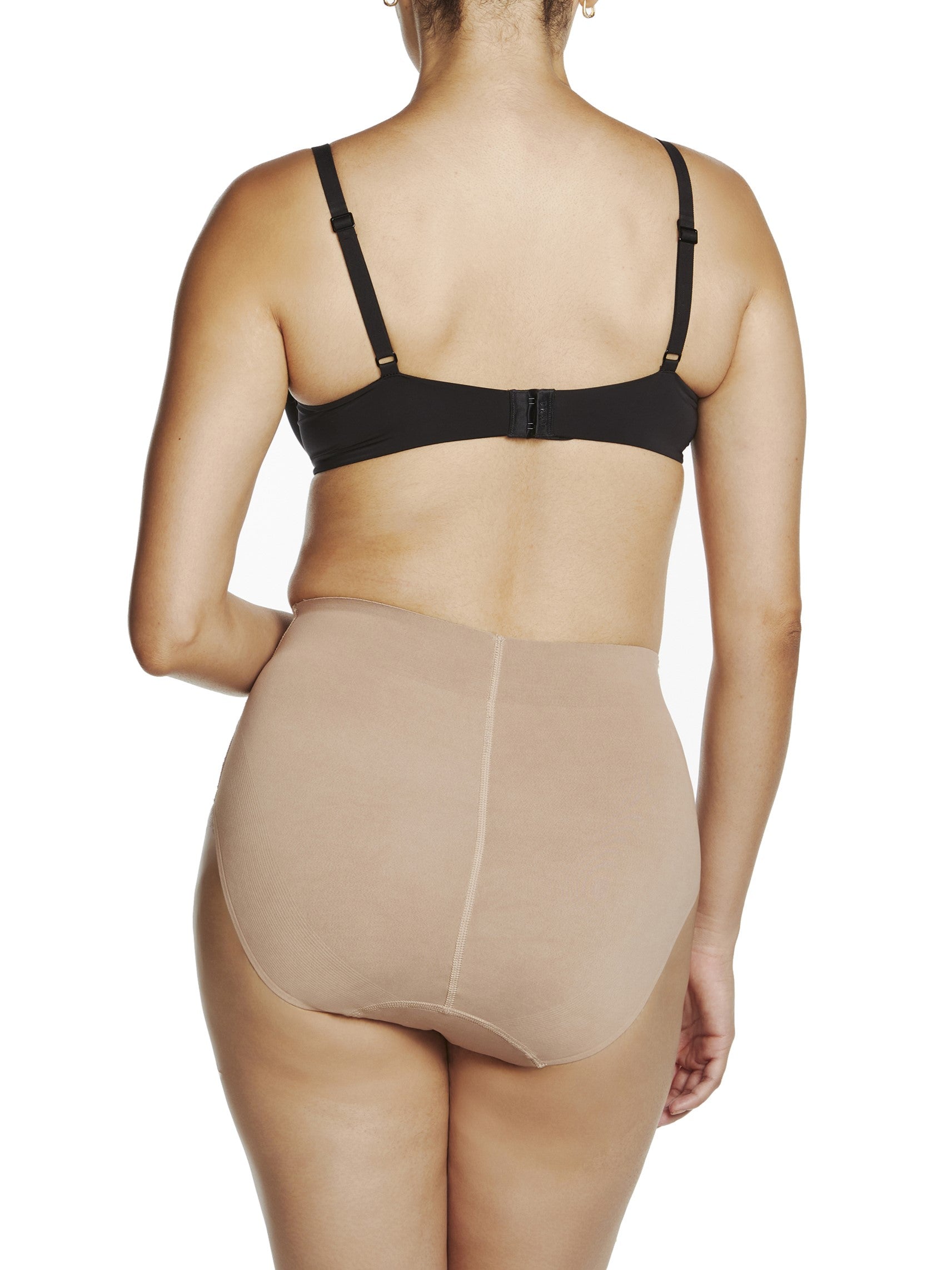 a woman wearing a beige shaping brief