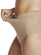 a close-up detail of a woman wearing a beige shaping brief