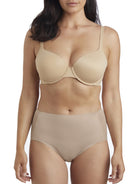 a woman wearing a beige shaping brief 