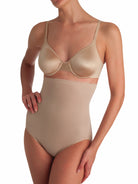 a woman wearing a beige shaping brief