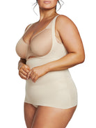 a woman wearing a nude plus size open bust shaping camisole tank top