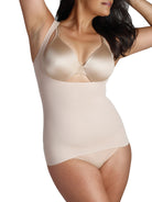 a woman wearing a beige open-bust shaping camisole