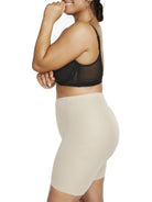 a woman wearing nude plus size tummy control shapewear shorts