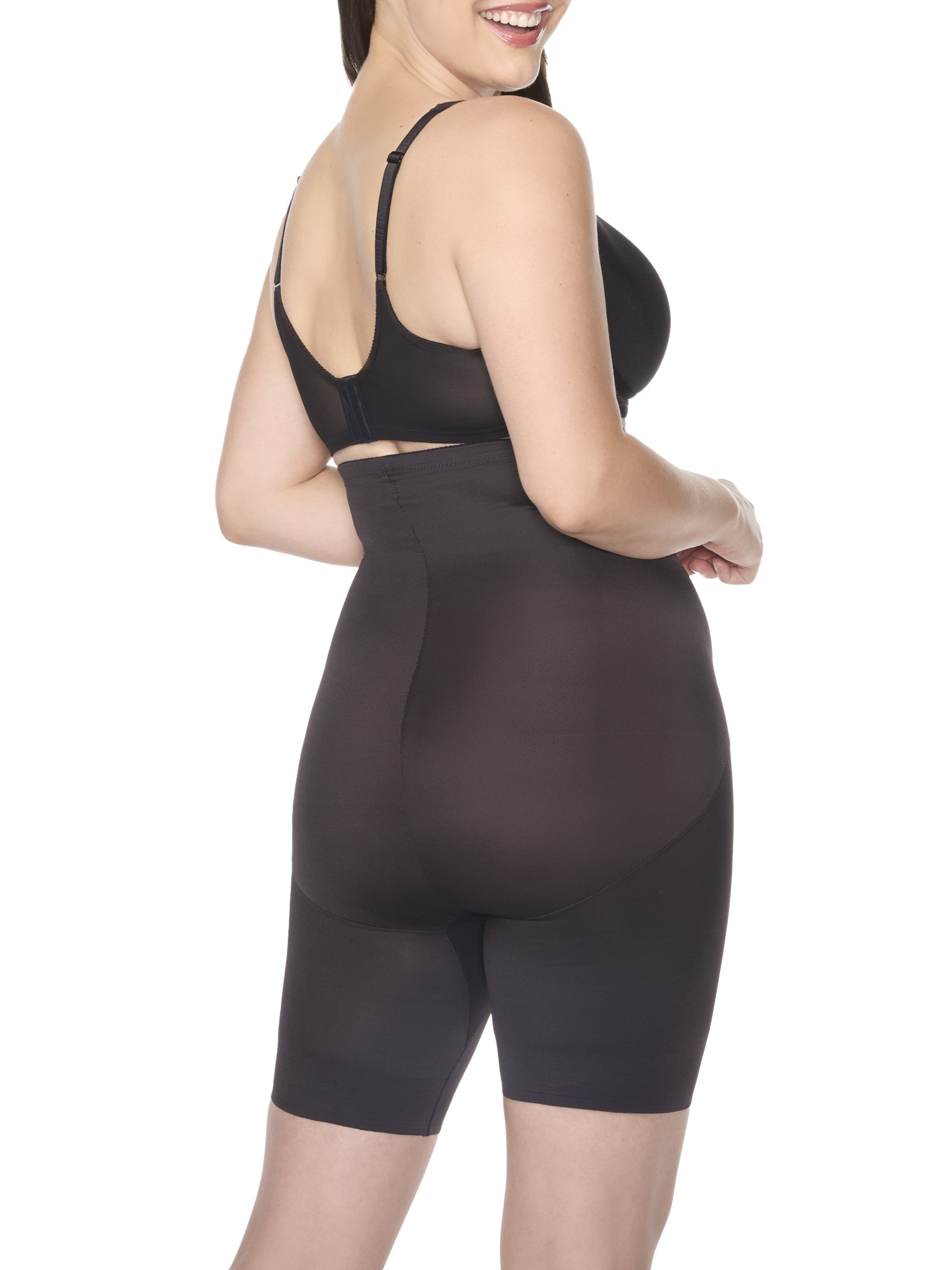 a woman wearing black high waisted tummy control shapewear shorts