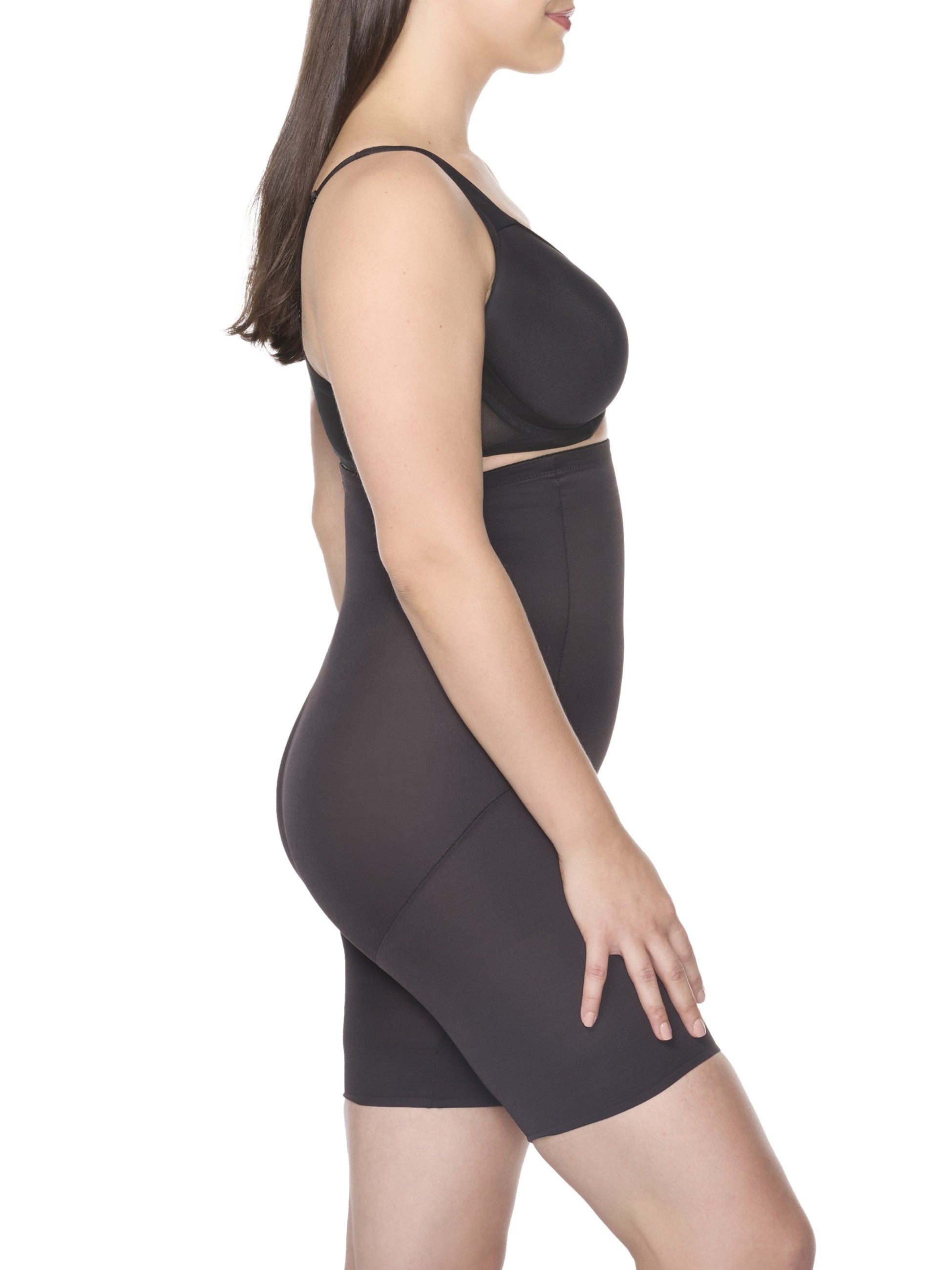 a woman wearing black high waisted tummy control shapewear shorts