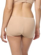 a woman wearing a beige boyshort boy short panty women's underwear