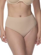 Beige underwear being worn by a person on a white background
