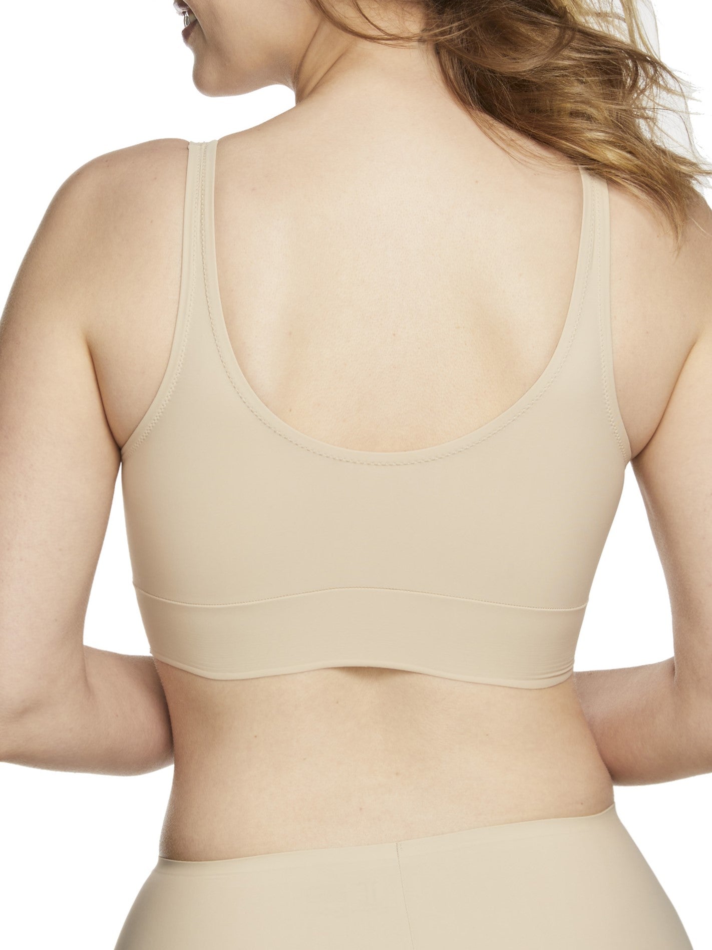 a woman wearing a beige bralette