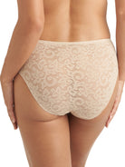 a woman wearing a nude lace high cut brief panty