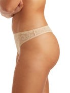 a woman wearing a beige thong panty