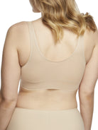 a woman wearing a beige bralette